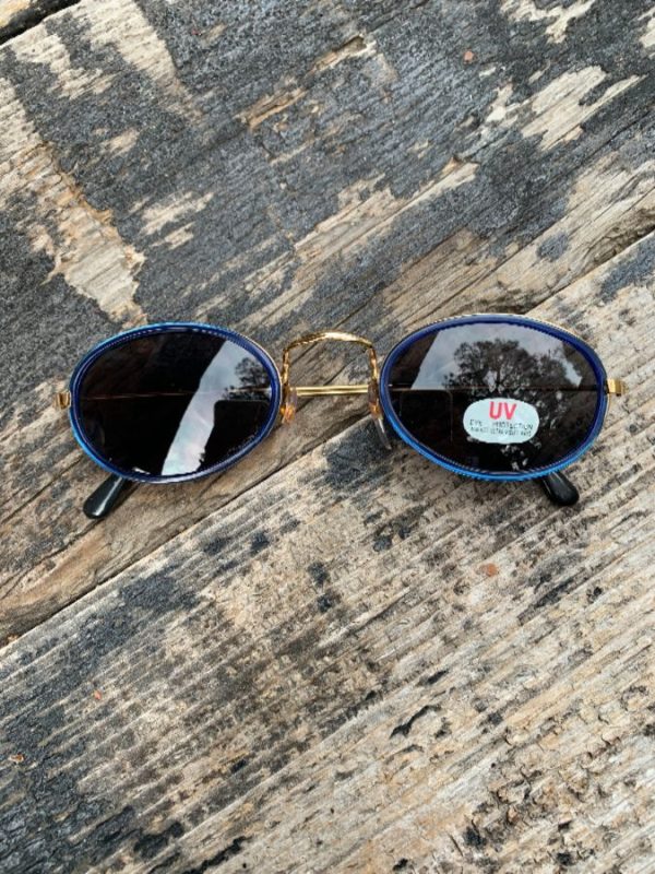 product details: DEADSTOCK BLUE RIMMED 1990S OVAL FRAME SUNGLASSES WITH ORIGINAL UV PROTECTION STICKER photo