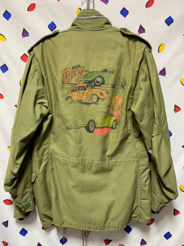 product details: MILITARY JACKET VIETNAM ERA DISTRESSED W/ WOODSTOCK PATCHES AND VW BUG BACK GRAPHIC photo