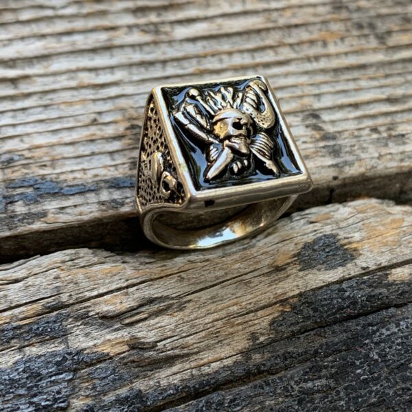 product details: PIRATE SKULL AND CROSSED CUTLASS BLACK ENAMEL THREE SIDED SILVER RING WITH FLAG AND SWORD THROUGH SKULL photo