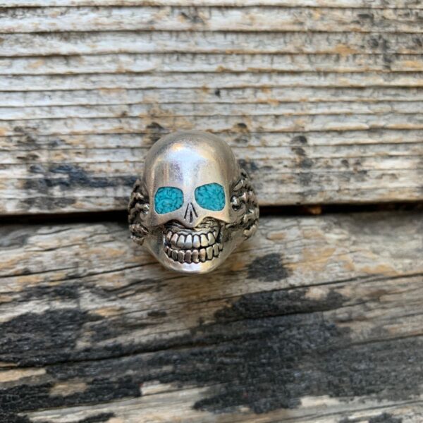 product details: GRINNING SILVER SKULL WITH CRUSHED TURQUOISE INLAY EYES BIKER RING photo