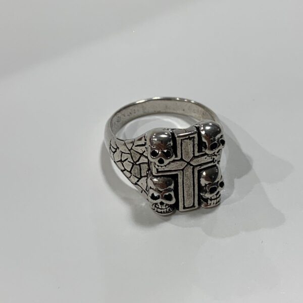 product details: FOUR CORNER SKULLS AND CROSS SILVER RING WITH CRACKED SAND TEXTURE SIDES photo