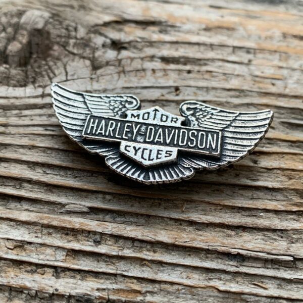 product details: VINTAGE DEADSTOCK CLASSIC HARLEY SHIELD WITH ANGEL WINGS HEAVY METAL BIKER PIN photo