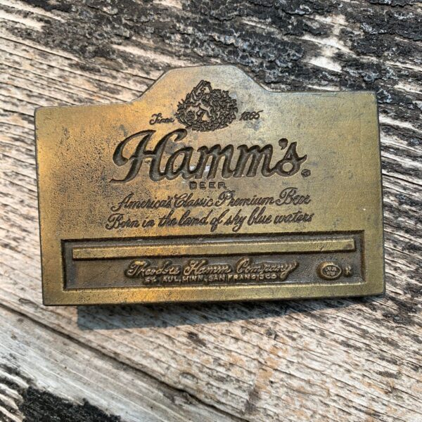 product details: VINTAGE HAMMS CLASSIC PREMIUM BEER FROM THE LAND OF SKY BLUE WATERS MINNESOTA SINCE 1865 SOLID BRASS BELT BUCKLE photo