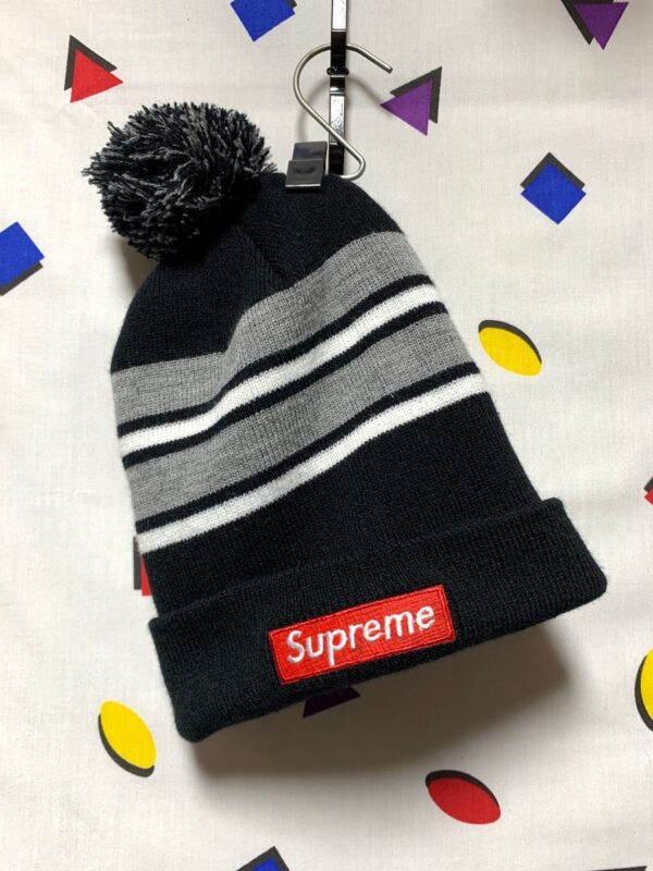 product details: SUPREME STRIPED POM POM BEANIE WITH SMALL EMBROIDERED SUPREME PATCH photo