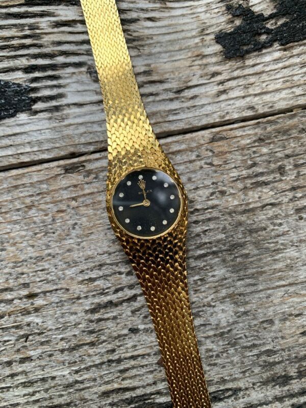 product details: WOVEN GOLDTONE LADIES ROLEX WATCH WITH RHINESTONE ACCENTED FACE/ SNAP-CLOSURE photo