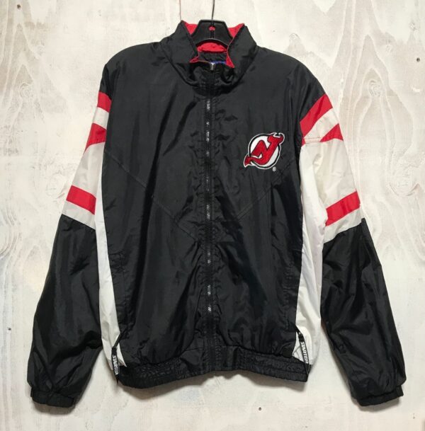 product details: NEW JERSEY DEVILS FRONT LOGO BACK LETTERING NHL HOCKEY WINDBREAKER JACKET WITH ZIP FRONT DUAL ZIPPER POCKETS NYLON LINING HIDDEN VELCRO HOODIE AS-IS photo