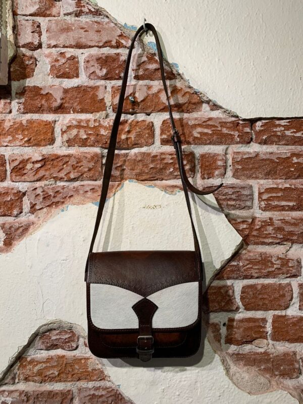 product details: SQUARE SHAPED LEATHER EMBOSSED COWHIDE SADDLE BAG W/ PONY HAIR DETAIL BUCKLE STRAP photo