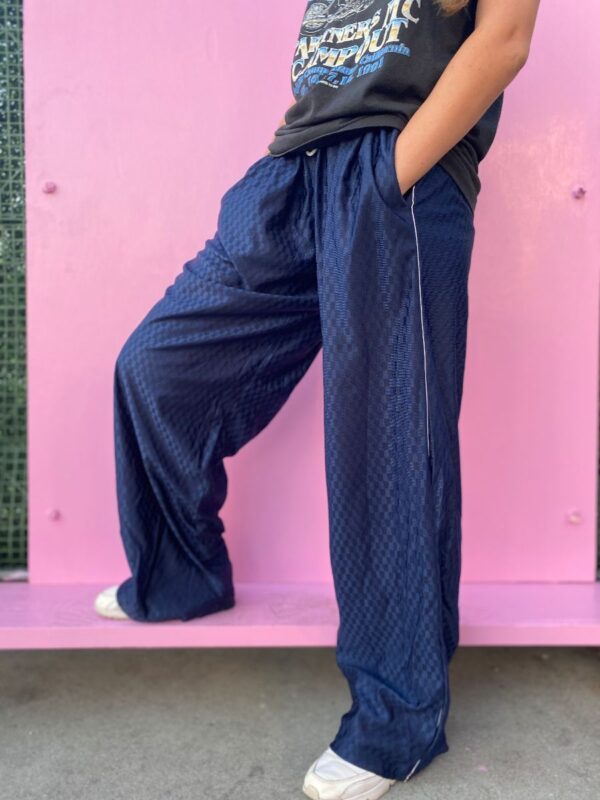 product details: 1990S  DEADSTOCK REFLECLTIVE CHECKERBOARD ATHLETIC PANTS WITH DRAWSTRING WAIST AND VERTICAL WHITE SIDE STRIPE photo