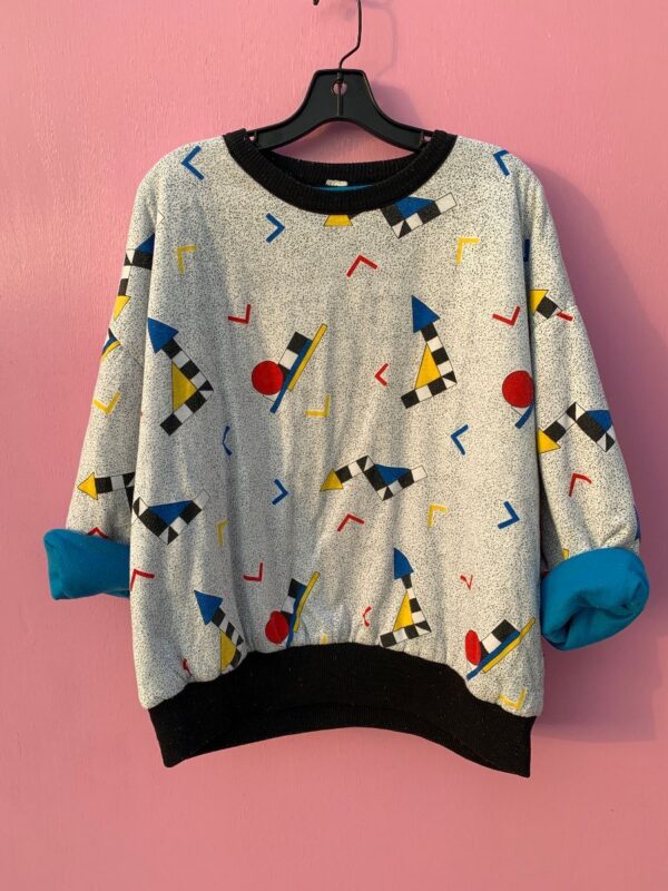 product details: PUFFY REVERSIBLE BLUE AND MEMPHIS GEOMETRIC SHAPES 80S SAVED BY THE BELL CREWNECK SWEATSHIRT photo