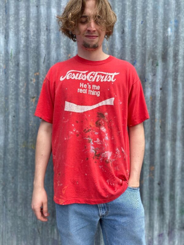 product details: DISTRESSED JESUS CHRIST COCA COLA PARODY T-SHIRT W/ PAINT SPLATTERS photo