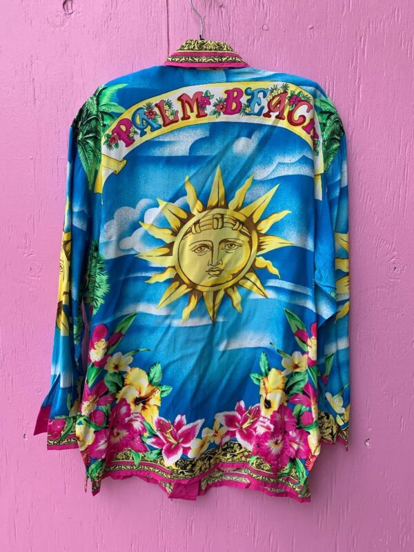 product details: INCREDIBLE LONG SLEEVE BUTTON DOWN COLLARED SHIRT WITH TROPICAL FLOWER PRINT AND BACK PALM BEACH SUN GRAPHIC photo