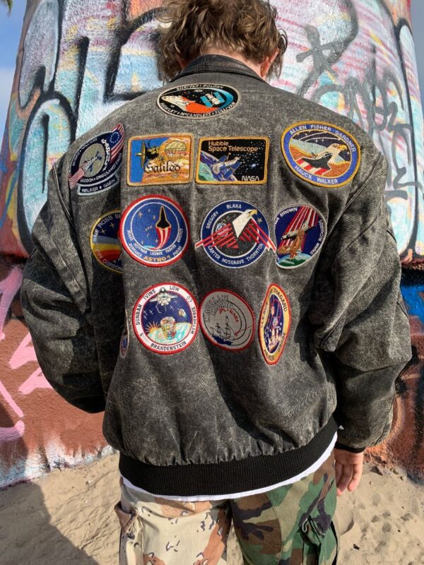 product details: UNREAL 1990S FULLY PATCHED NASA THEMED ACID WASH DENIM BOMBER JACKET WITH LEATHER COLLAR photo