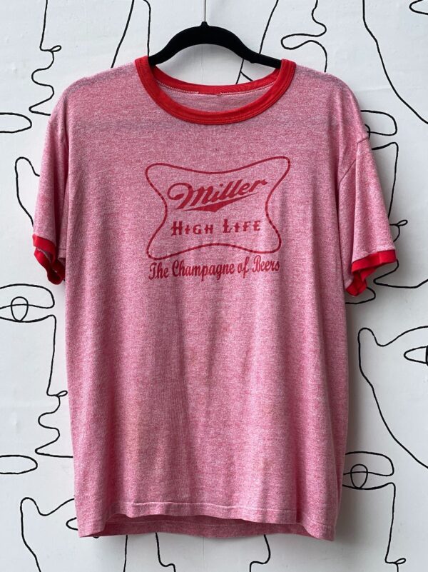 product details: AS IS - SUPER THIN GRAINY MILLER HIGH LIFE THE CHAMPAGNE OF BEERS GRAPHIC RINGER T-SHIRT photo