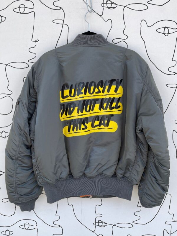 product details: GOOGLE COLLAB REVERSIBLE TWO-TONE CURIOSITY DID NOT KILL THIS CAT BOMBER JACKET photo