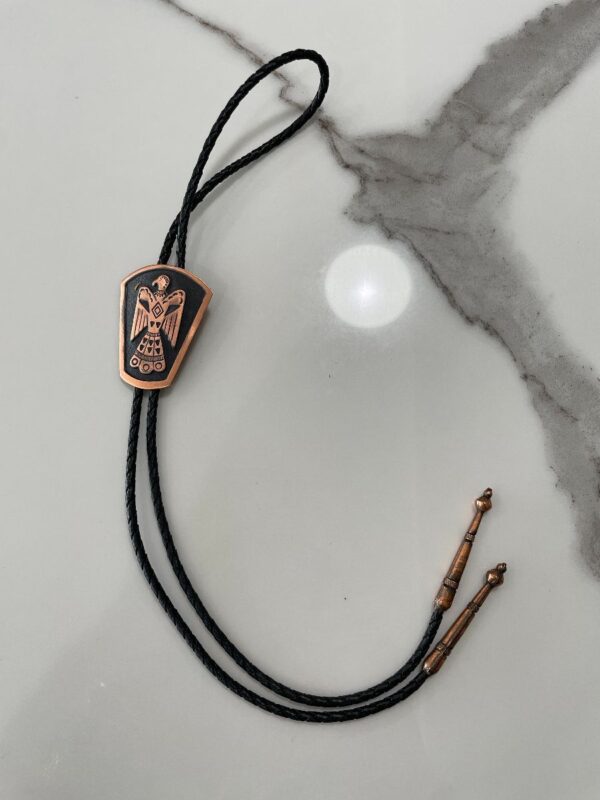 product details: COPPER THUNDERBIRD PLAQUE BOLO TIE BRAIDED LEATHER CORD photo
