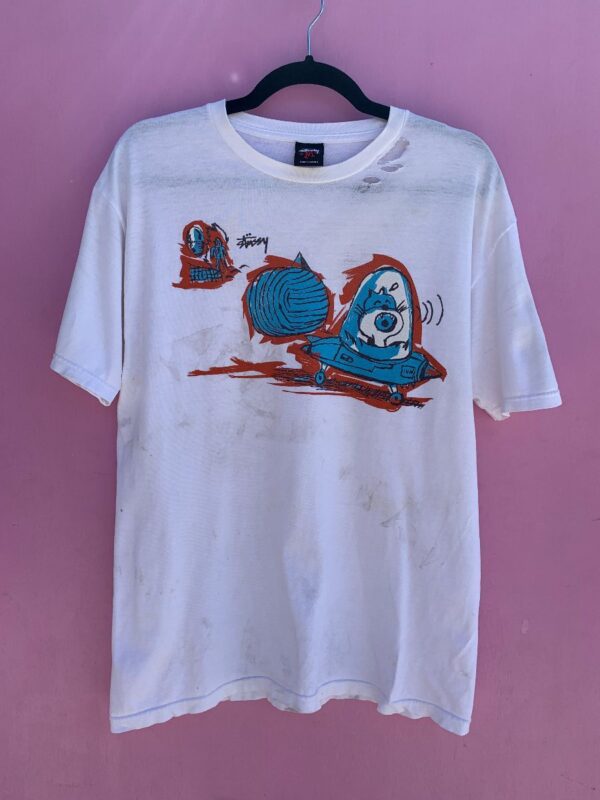 product details: AS-IS STUSSY T-SHIRT W/ SPACESHIP CAT AND BRUSH STROKE GRAPHIC photo