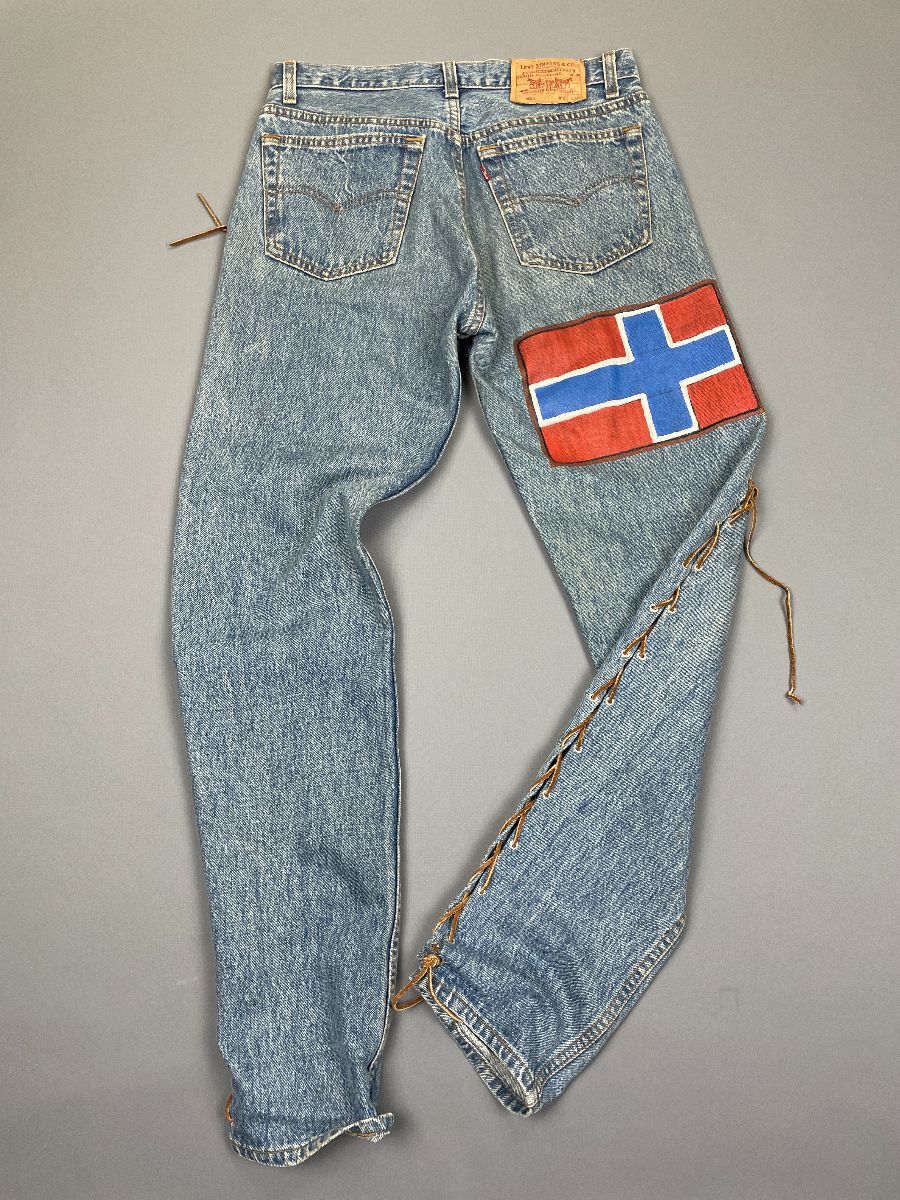 product details: AS-IS LEVIS 501 BUTTON FLY DENIM JEANS W/ LEATHER LACEUP SIDES AND HAND PAINTED NORWEGIAN FLAG photo