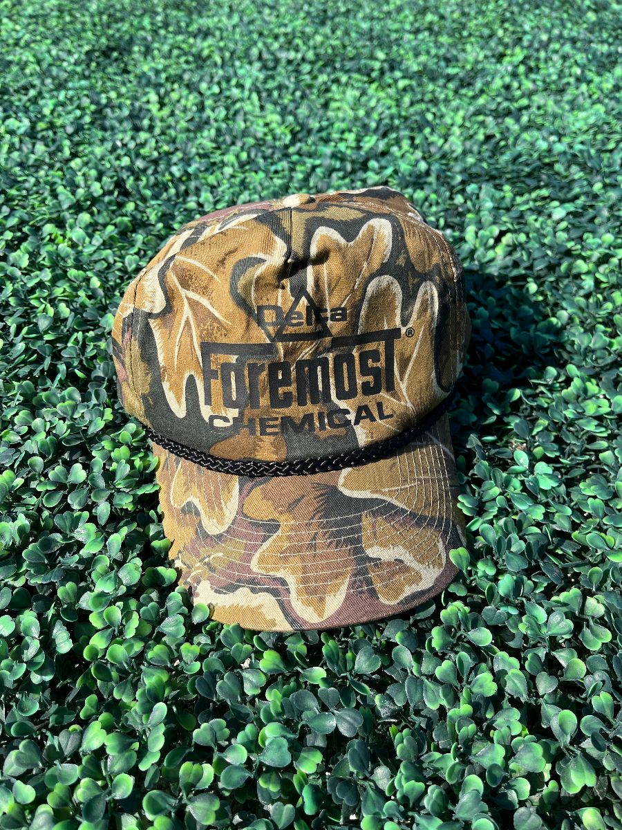 product details: DELTA FOREMOST CHEMICAL LOGO DESIGN REAL TREE LEAF CAMO SNAPBACK TRUCKER HAT photo