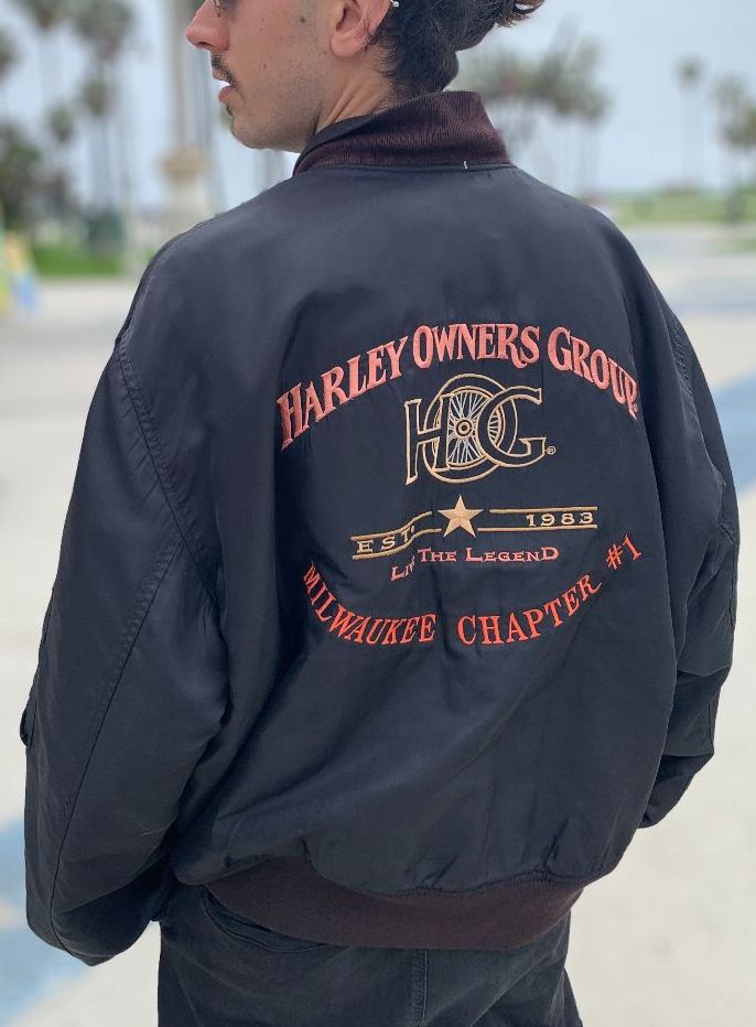 product details: MILWAUKEE CHAPTER #1 HARLEY OWNERS GROUP WITH LEATHER H.O.G PATCH RED INNER LINING MULTIPOCKET  BOMBER JACKET. photo