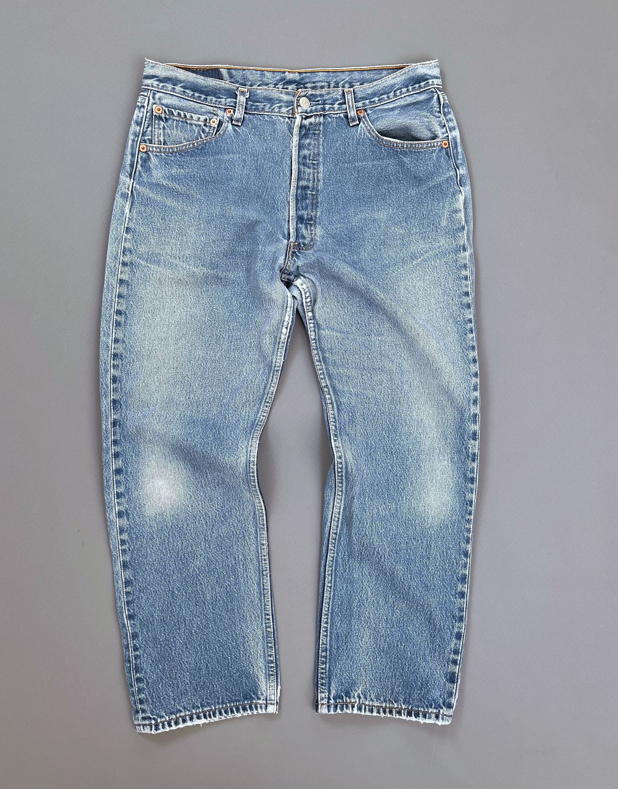 product details: LEVIS 501 LIGHTLY DISTRESSED CLASSIC WASH RED TAB BUTTON FLY DENIM JEANS photo