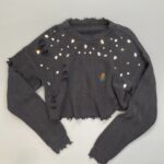 REWORKED & DISTRESSED CABLE KNIT CROPPED SWEATER RHINESTONE DETAILS & EMBROIDERED LOGO