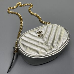 Photo detail:AS-IS CHANEL METALLIC SILVER OVAL CROSSBODY BAG W/ CHAIN STRAP AND BELT LOOPS