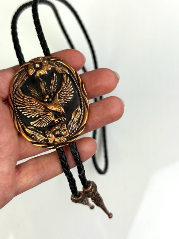ORNATE EAGLE COPPER BOLO TIE, BLACK BRAIDED LEATHER CORD, DECORATIVE END TIPS