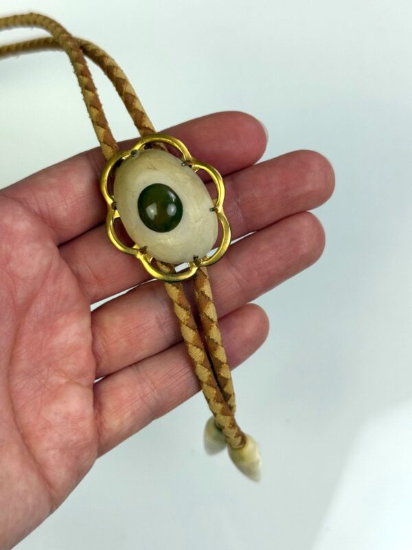 GOLD FRAMED CABOCHON BOLO TIE, CARVED BONE TIPS, 2-TONE BRAIDED LEATHER CORD