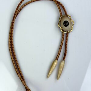 Photo detail:GOLD FRAMED CABOCHON BOLO TIE, CARVED BONE TIPS, 2-TONE BRAIDED LEATHER CORD