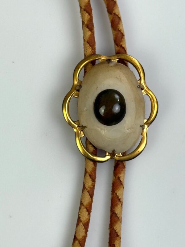 GOLD FRAMED CABOCHON BOLO TIE, CARVED BONE TIPS, 2-TONE BRAIDED LEATHER CORD