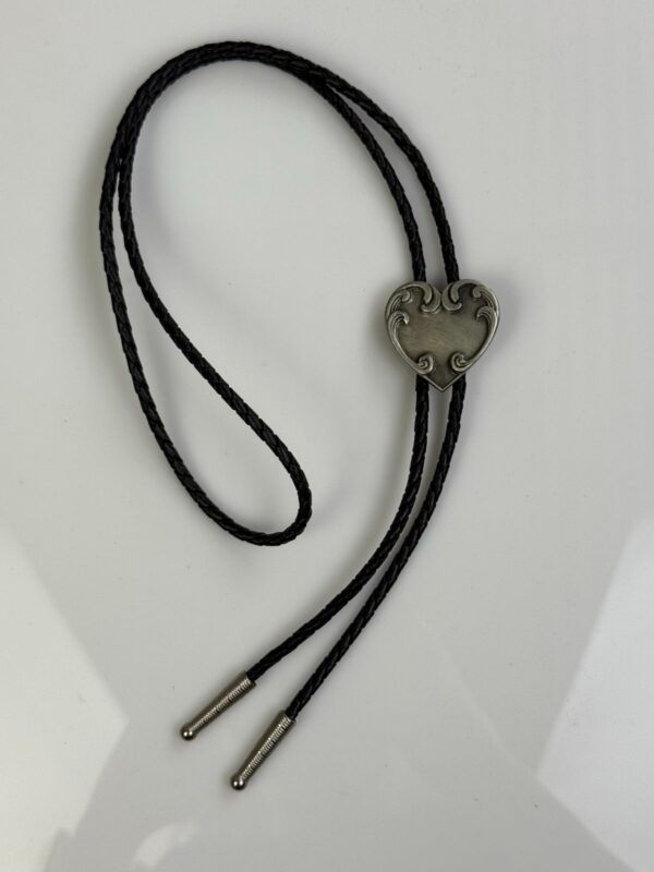 ORNATE HEART PENDANT BOLO TIE, BRAIDED LEATHER CORD