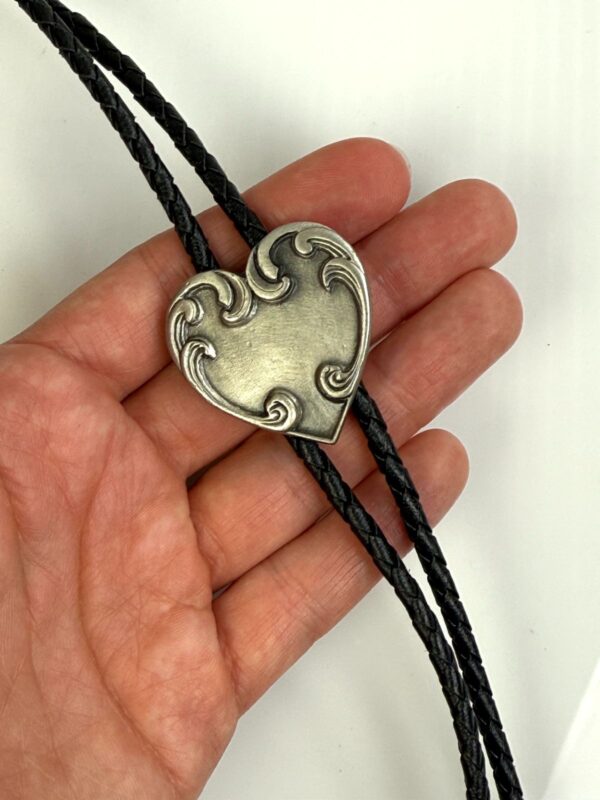 ORNATE HEART PENDANT BOLO TIE, BRAIDED LEATHER CORD