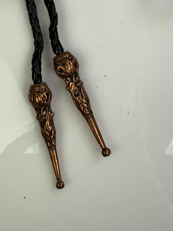 ORNATE EAGLE COPPER BOLO TIE, BLACK BRAIDED LEATHER CORD, DECORATIVE END TIPS