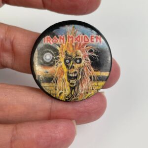 Photo detail:ORIGINAL 1980S IRON MAIDEN EDDIE YELLOW BRICK WALL GRAPHIC BUTTON PIN