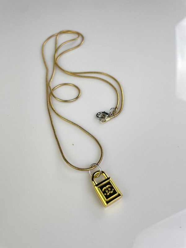 CHANEL PADLOCK CHARM NECKLACE 1980S GOLD PLATED SNAKE CHAIN NECKLACE, SILVER DETAILS