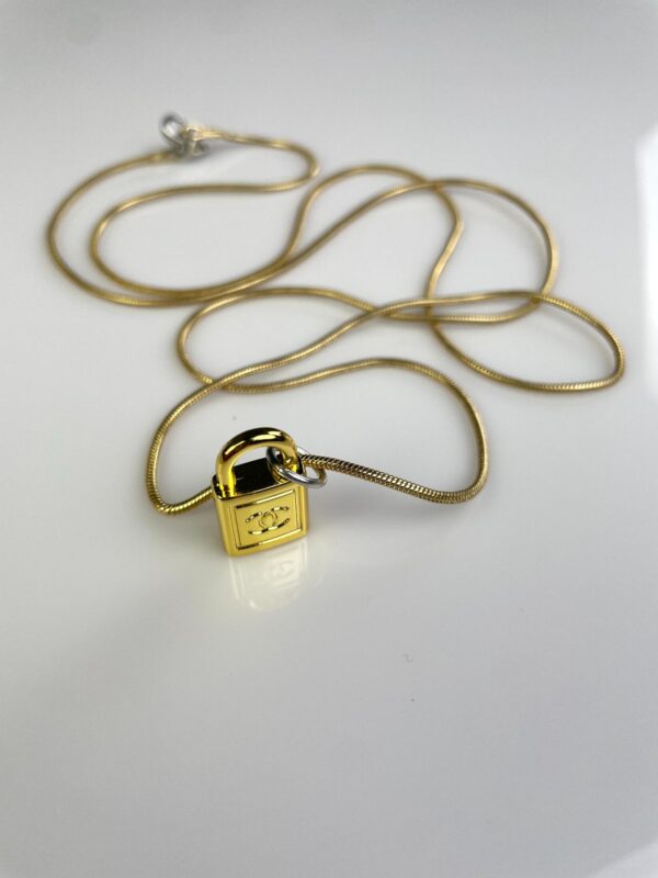 CHANEL PADLOCK CHARM NECKLACE 1980S GOLD PLATED SNAKE CHAIN NECKLACE, SILVER DETAILS