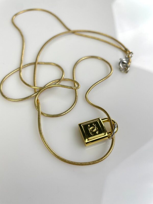 CHANEL PADLOCK CHARM NECKLACE 1980S GOLD PLATED SNAKE CHAIN NECKLACE, SILVER DETAILS