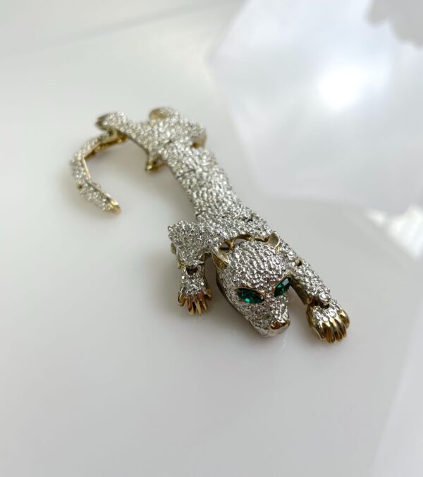 1990S SILVER ARTICULATED PANTHER OVER THE SHOULDER BROOCH, GREEN JEWEL EYES