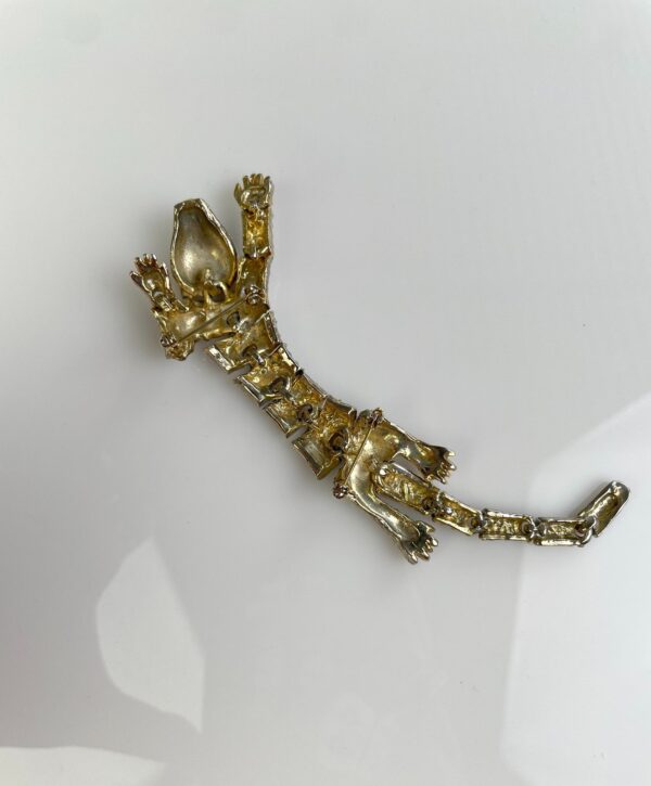 1990S SILVER ARTICULATED PANTHER OVER THE SHOULDER BROOCH, GREEN JEWEL EYES