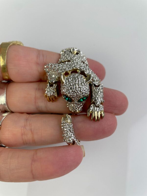 1990S SILVER ARTICULATED PANTHER OVER THE SHOULDER BROOCH, GREEN JEWEL EYES