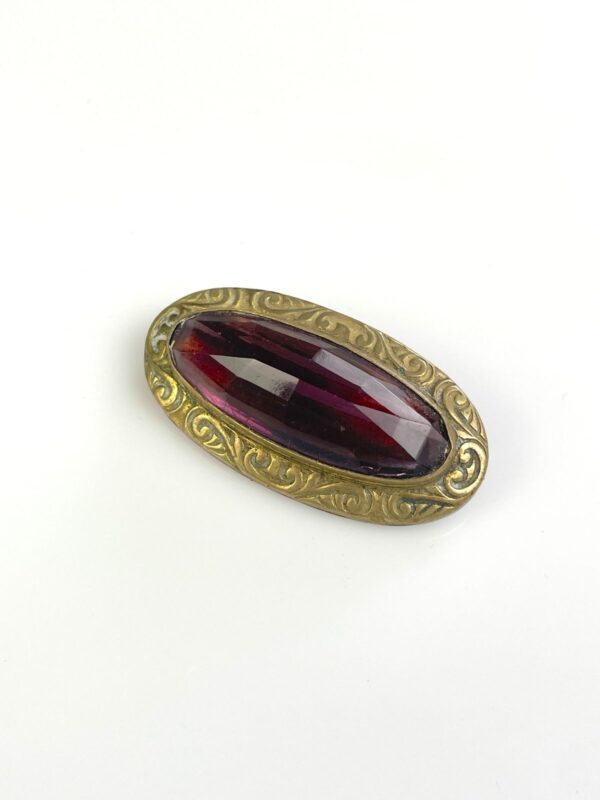ORNATELY STAMPED ANTIQUE BRASS BROOCH, FACETED AMETHYST STONE