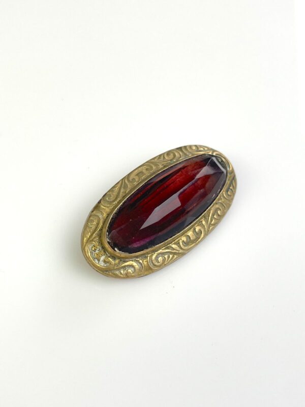 ORNATELY STAMPED ANTIQUE BRASS BROOCH, FACETED AMETHYST STONE