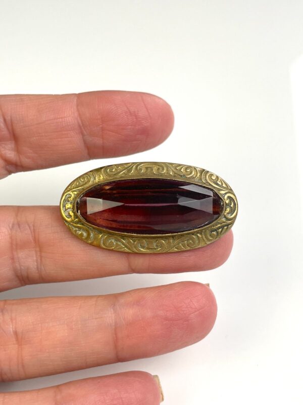 ORNATELY STAMPED ANTIQUE BRASS BROOCH, FACETED AMETHYST STONE