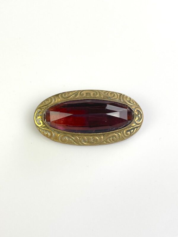 ORNATELY STAMPED ANTIQUE BRASS BROOCH, FACETED AMETHYST STONE