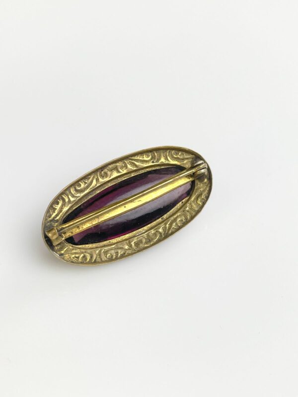 ORNATELY STAMPED ANTIQUE BRASS BROOCH, FACETED AMETHYST STONE