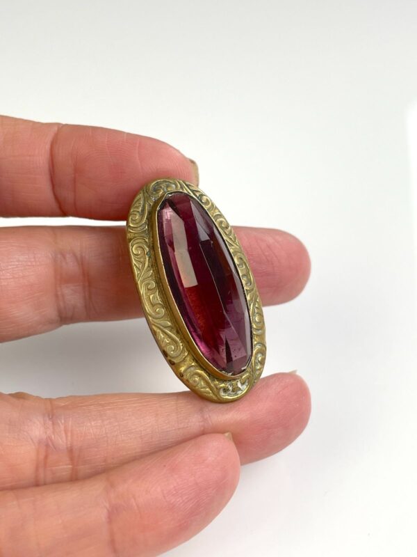ORNATELY STAMPED ANTIQUE BRASS BROOCH, FACETED AMETHYST STONE