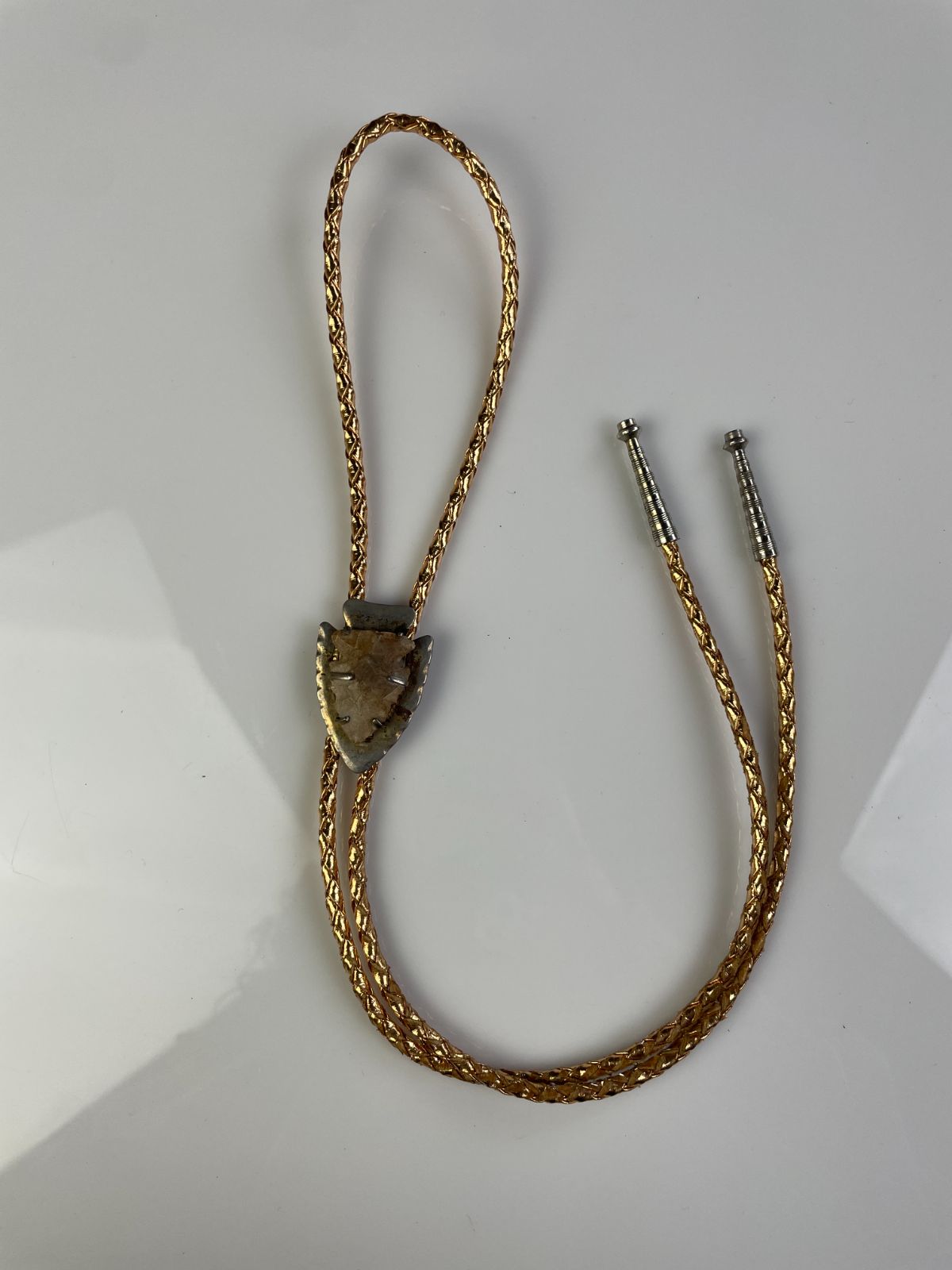 product details: MOUNTED ARROWHEAD BOLO TIE, METALLIC BRAIDED CORD photo