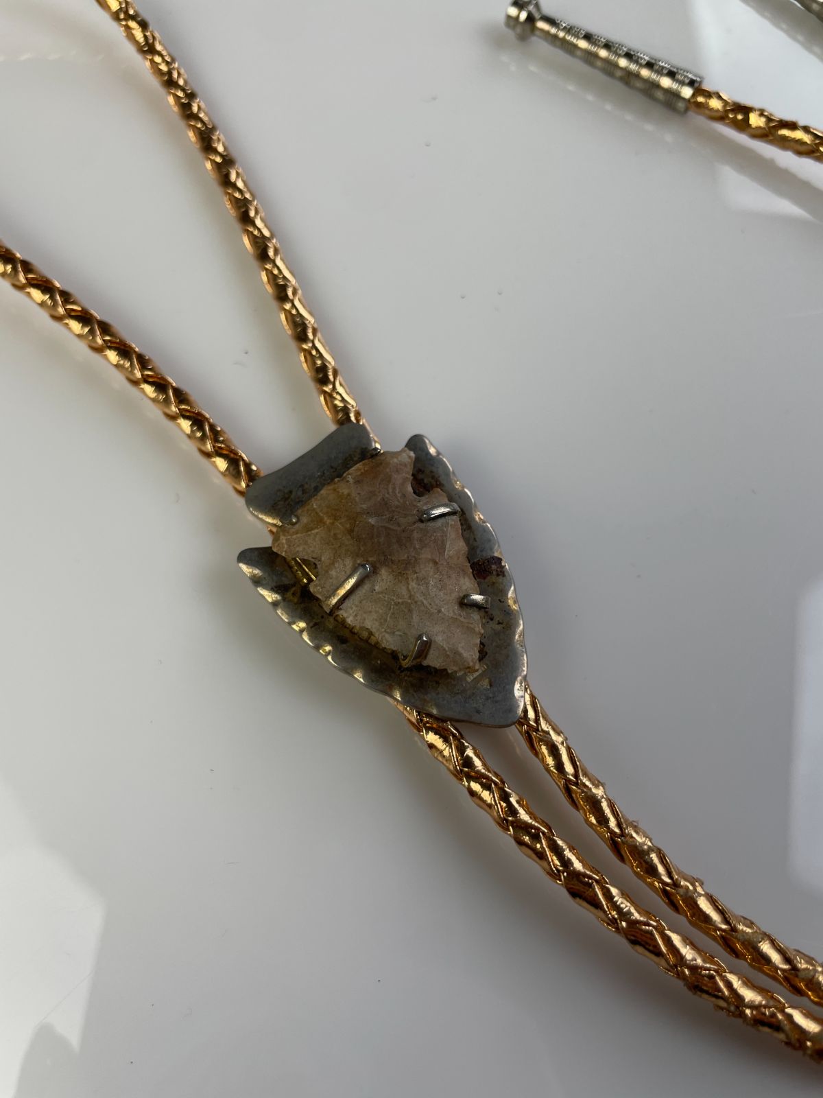 product details: MOUNTED ARROWHEAD BOLO TIE, METALLIC BRAIDED CORD photo