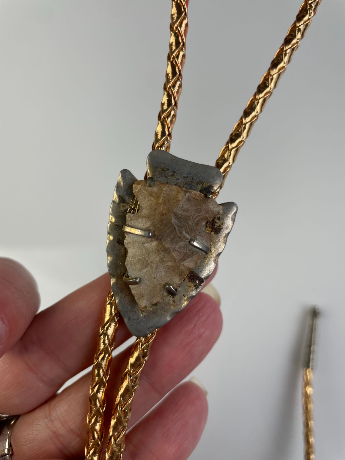 product details: MOUNTED ARROWHEAD BOLO TIE, METALLIC BRAIDED CORD photo