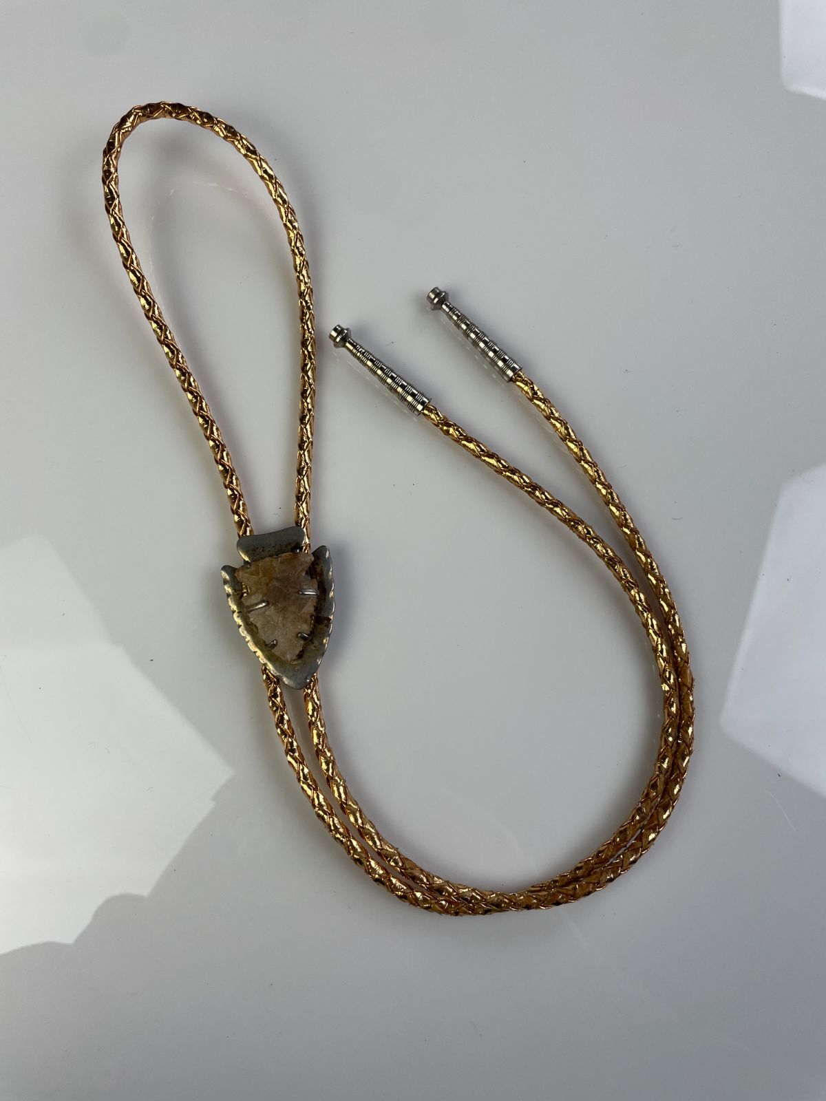 product details: MOUNTED ARROWHEAD BOLO TIE, METALLIC BRAIDED CORD photo
